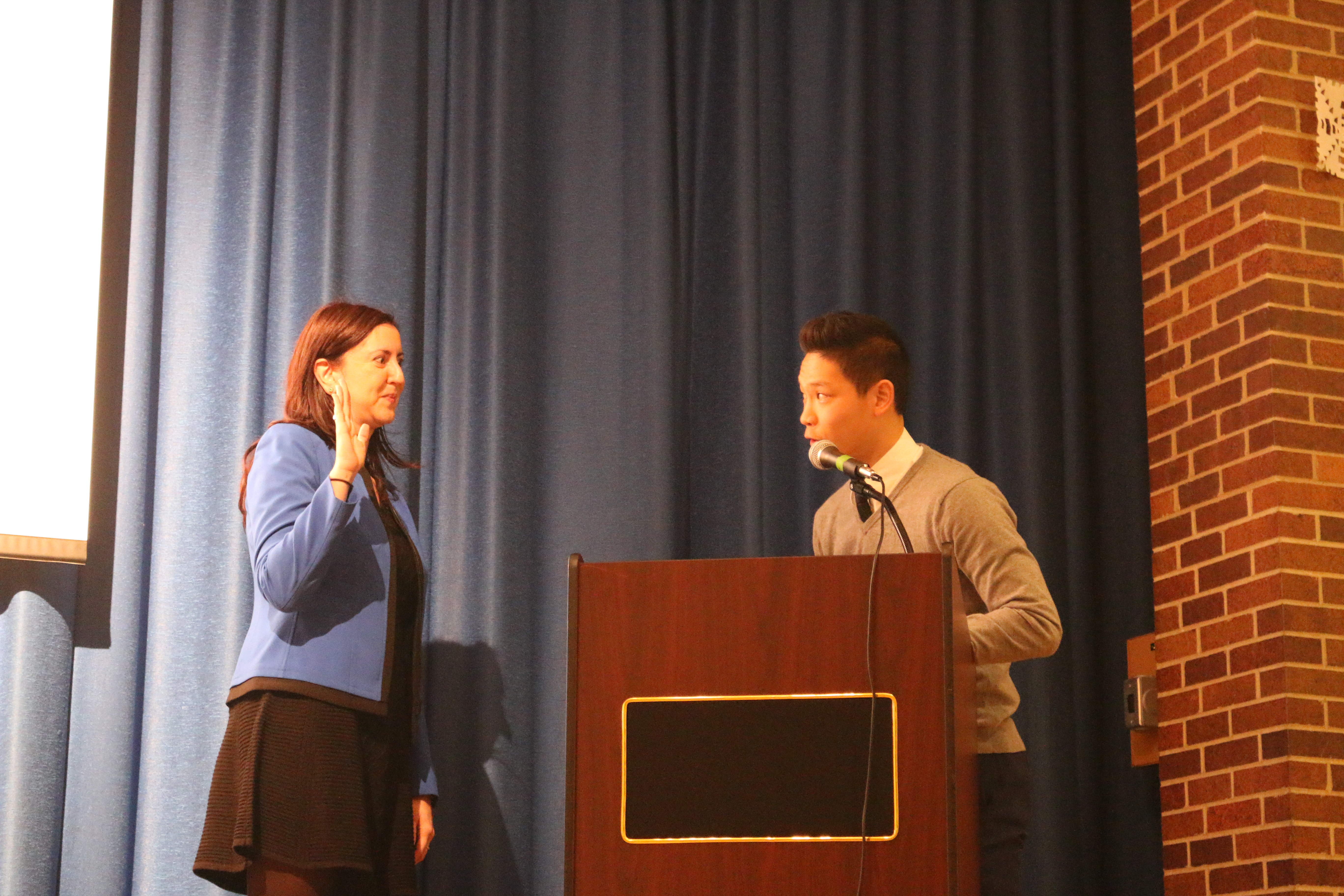 Student Body President, Corey Cheung, symbolically installs Assemblywoman Rozic to her third term in office.